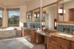 The en-suite bathroom is spacious and luxurious with his and her vanities